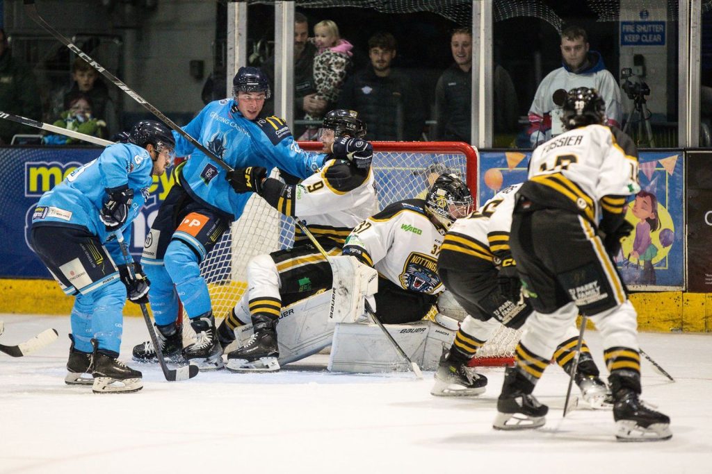 Goal mouth scramble with Kevin Carr making a diving save.