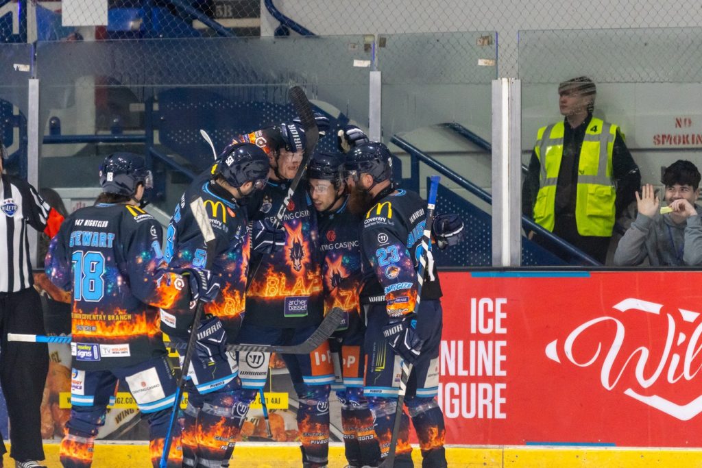 Blaze players celebrate Constable's goal in special Bonfire Night jerseys