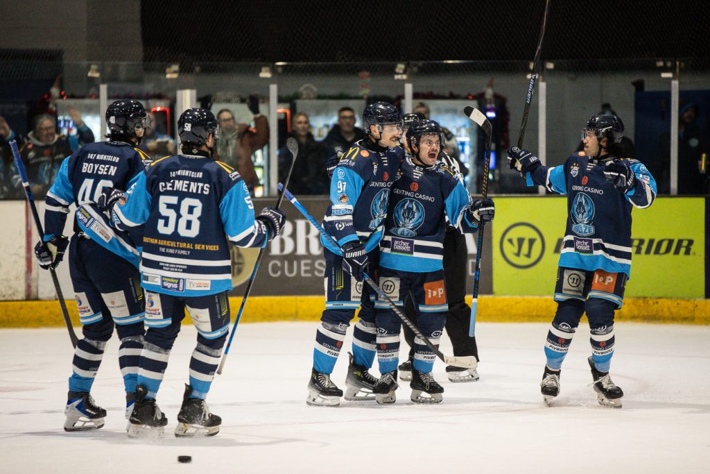 Gleason celebrates with teammates after scoring his second goal. 