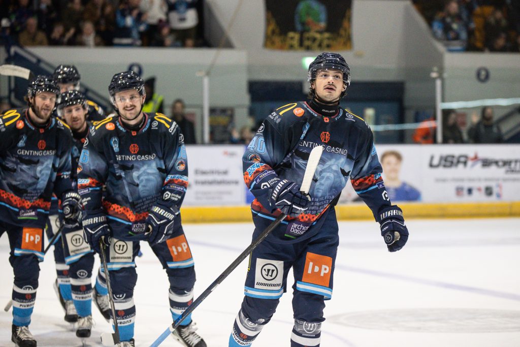 Boysen skates to the Blaze bench followed by teammates after scoring. 