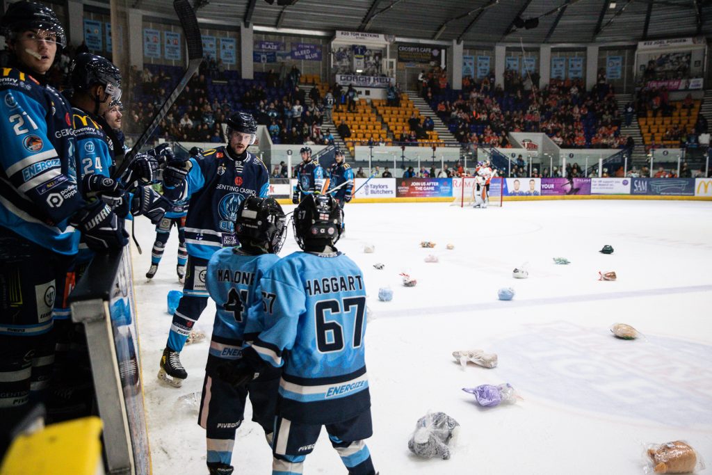 Vertanen skates to the Blaze bench after scoring with soft toys on the ice. 