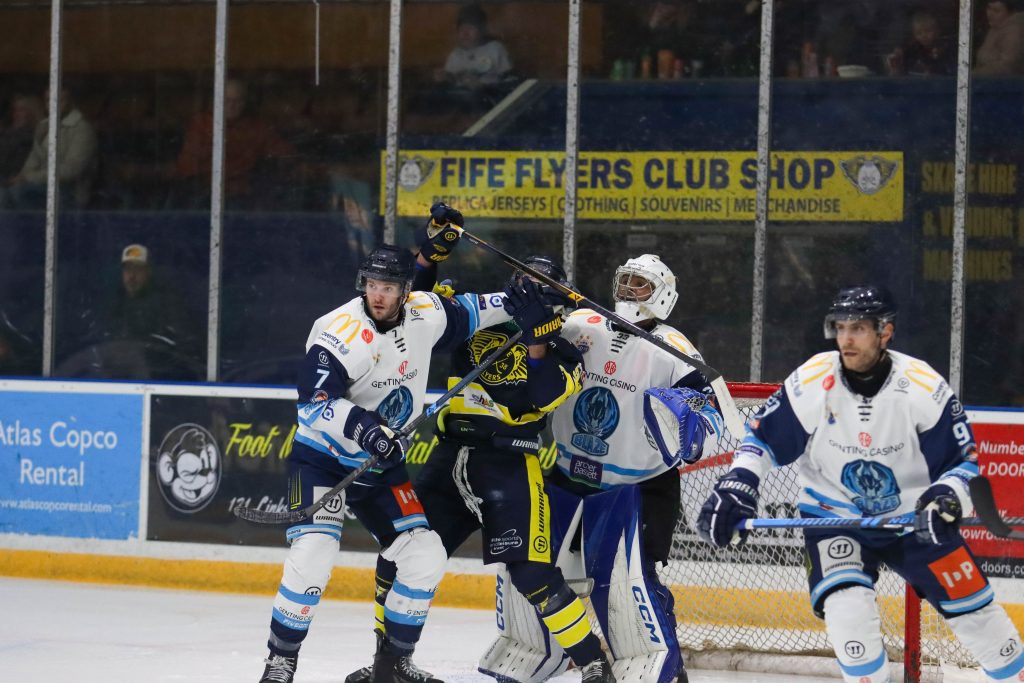 Russell battles a Fife player in front of Stewart's net.