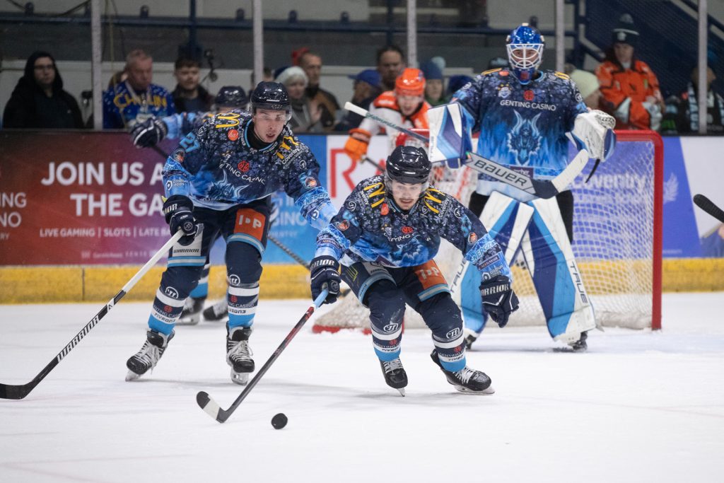 Matthew Gleason skates up the ice against the Steelers with Mat Robson and Mike Pelech in the distance.