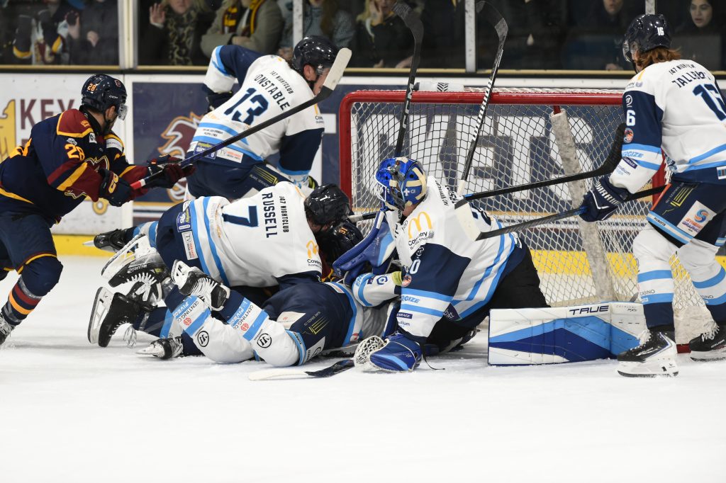 Blaze players around Robson's net defending. 