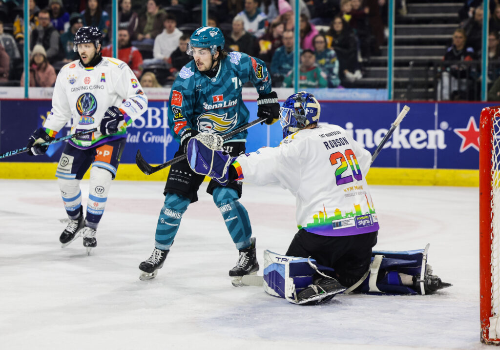 Robson makes a save with a Belfast player providing a screen in front. 