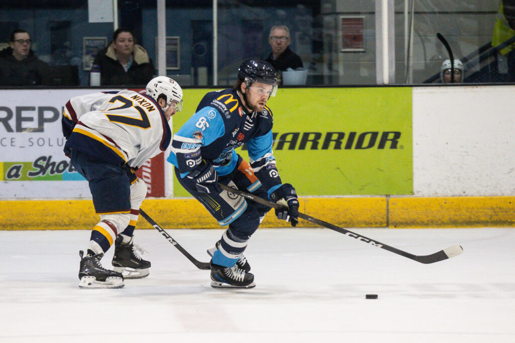 Mismash skates with puck.