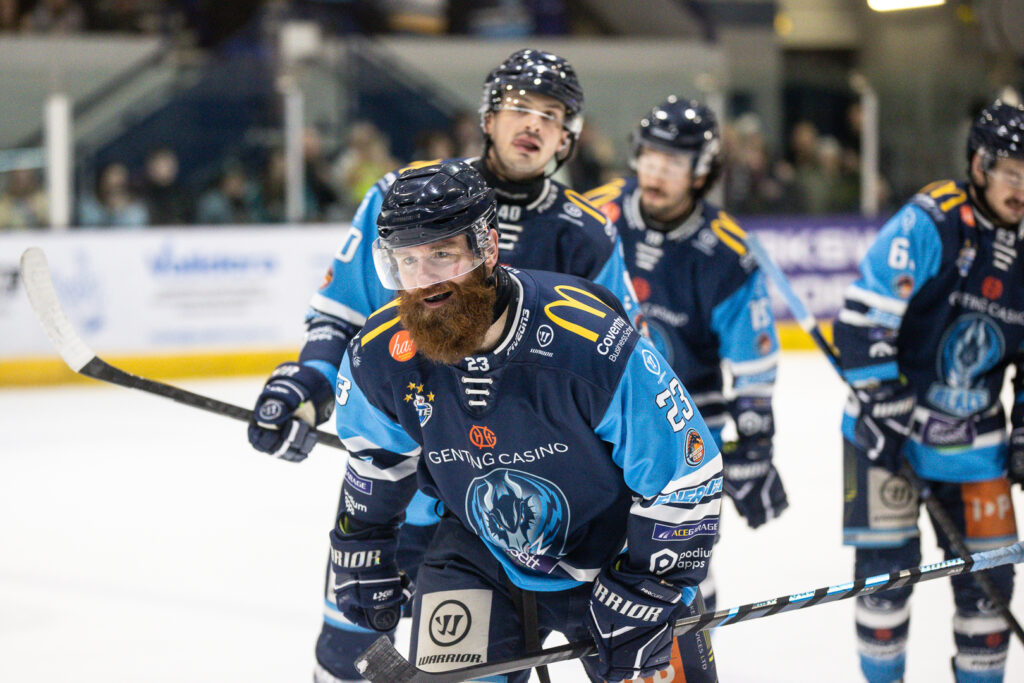 Saucerman skates towards the Blaze bench smiling after scoring.
